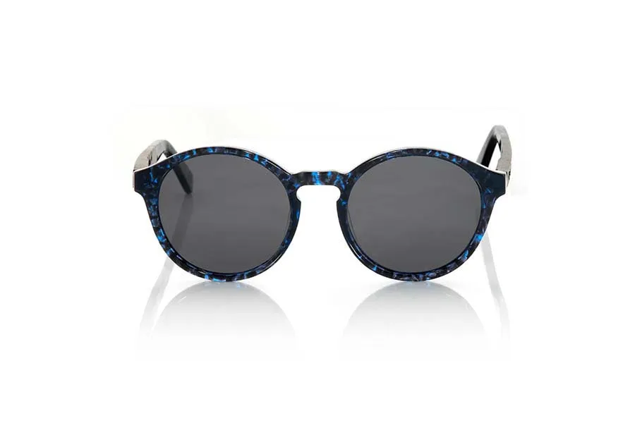 Wood eyewear of Ebony ZORGE. ZORGE sunglasses of the MIXED PREMIUM series are manufactured with the front in acetate quality in color black with blue sparkles carey and sideburns in natural EBONY wood finished in Rod covered with acetate carey with blue flashes that can be adjusted if necessary. It's a model rounded suggestive shapes that are perfectly to people of both sexes and have been combined with grey lenses or blue REVO series. The quality of the materials and their perfect completion will surprise you. Front size: 140x51mm for Wholesale & Retail | Root Sunglasses® 